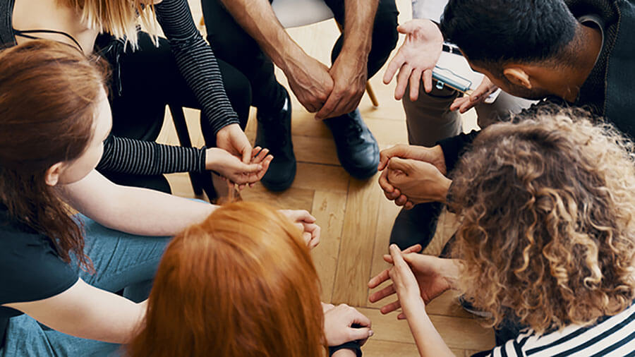 A group of people holding hands. Credit: iStock/KatarzynaBialasiewicz