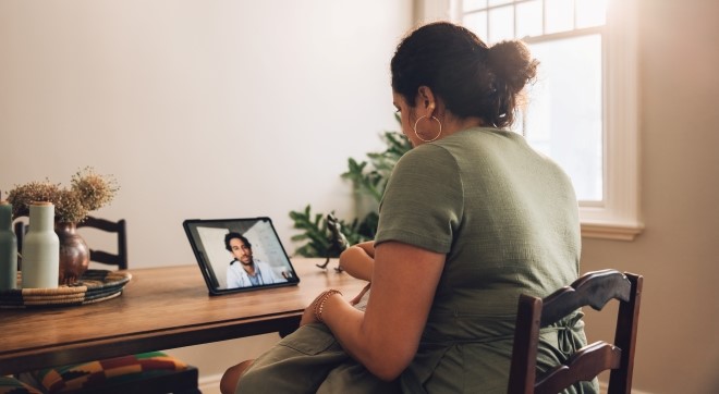 Woman and healthcare provider during a telehealth visit