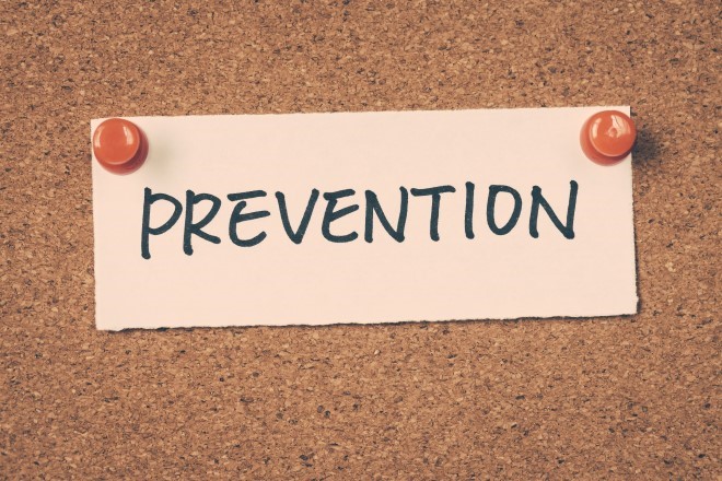 The word "prevention" written on a piece of paper and tacked to a bulletin board