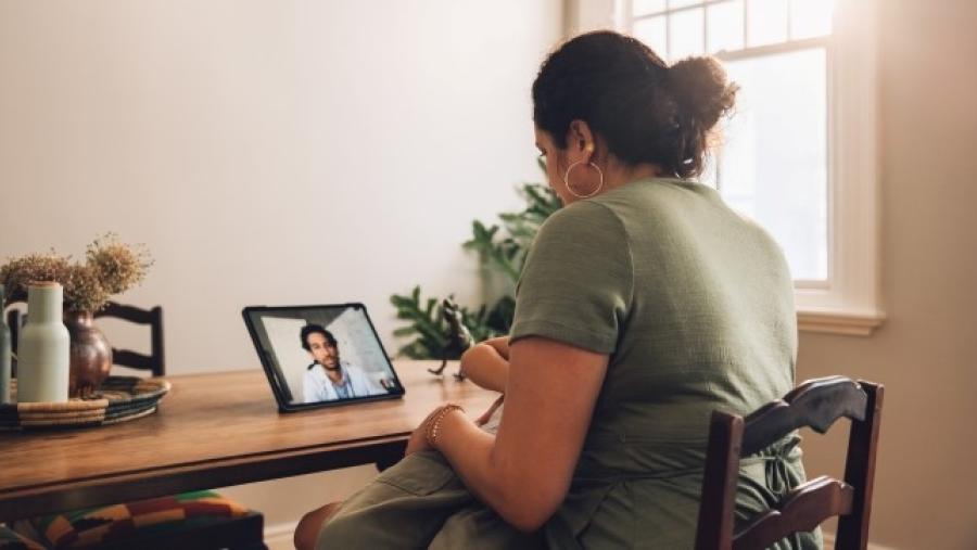 Woman and healthcare provider during a telehealth visit