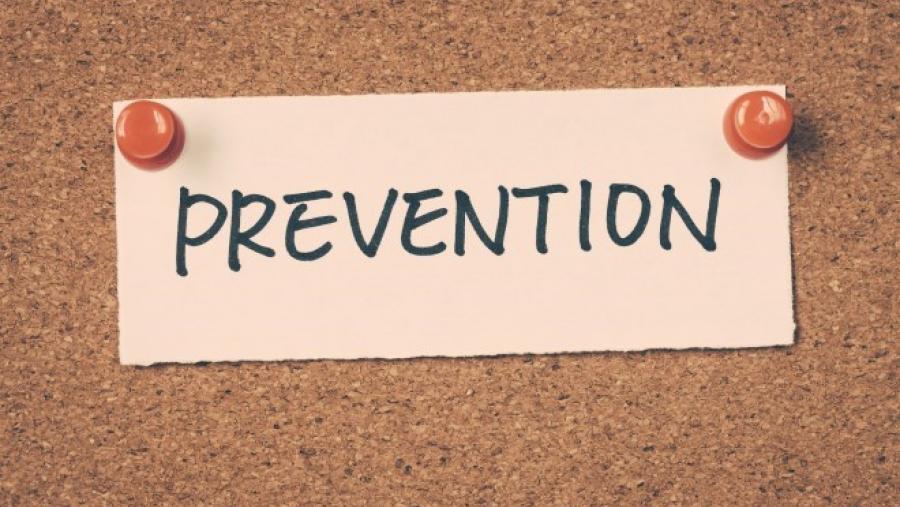 The word "prevention" written on a piece of paper and tacked to a bulletin board