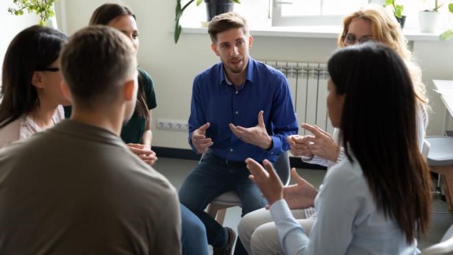 Diverse group of people sitting in a circle talking