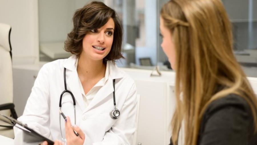 doctor talking to a young woman patient